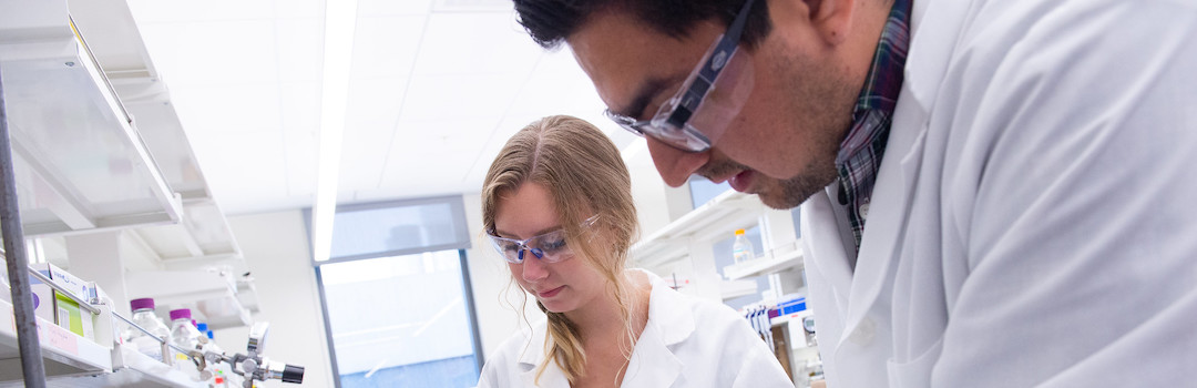 a man and woman working in lab