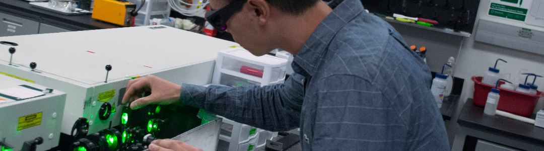 Person with goggles working in a lab