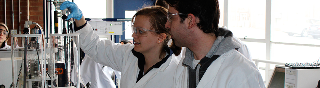 Male and female undergraduate students working in chemical engineering lab