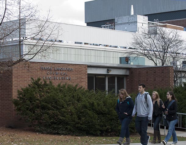 exterior shot of a classroom building with students passing by