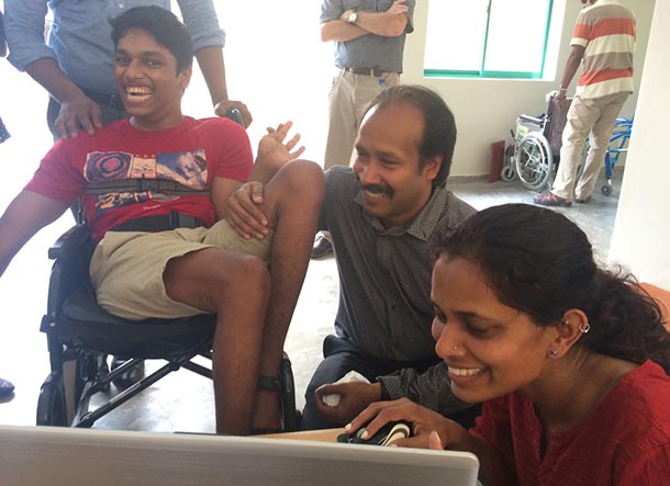 Nimisha Muttiah shows a high school student in Sri Lanka and his father how to use the Voz Box.