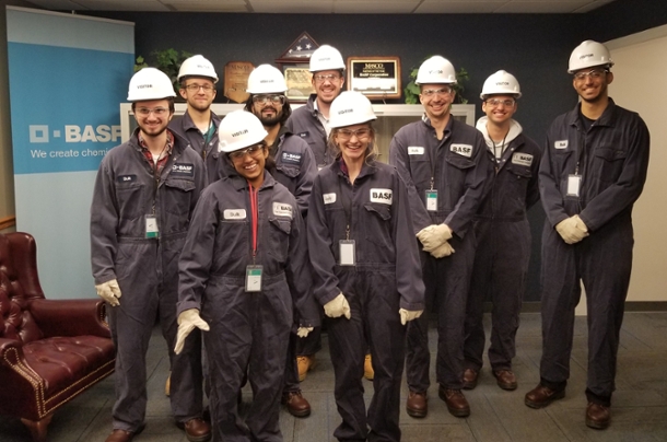 Group of students in full chemical plant safety gear