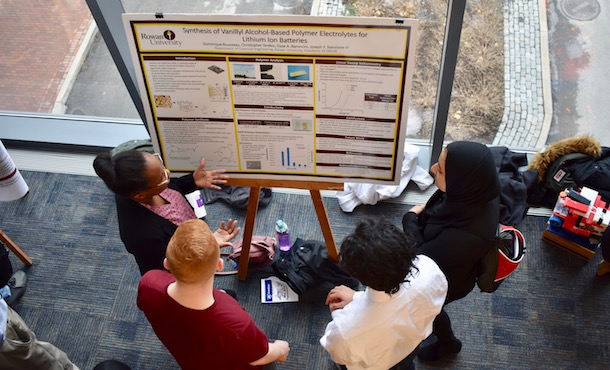 overhead view of people discussing a poster